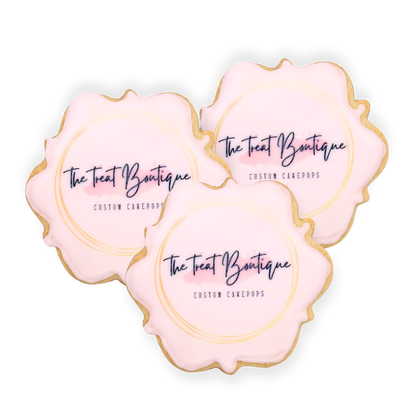 Three scalloped cookies printed with The Treat Boutique's logo with no background.