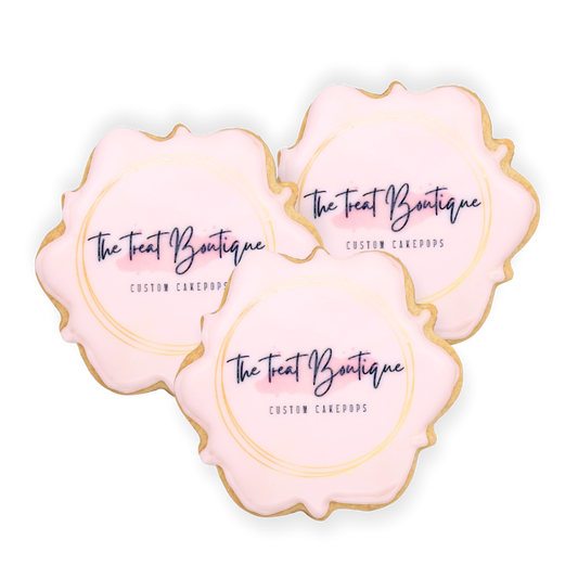 Three scalloped cookies printed with The Treat Boutique's logo with no background.